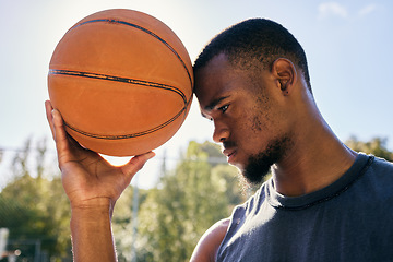 Image showing Basketball on forehead, motivation and black man on basketball court ready for competition, match or game. Basketball player, sports and male from Nigeria preparing for training, fitness or exercise.