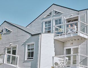 Image showing Couple, love and breakfast on the balcony while on vacation together for bonding. House, holiday and young man and woman drinking tea or coffee with a meal in a romantic relationship on home patio