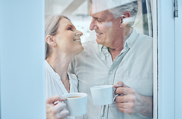 Image showing Retirement, coffee and love with a senior couple drinking or enjoying a beverage together in their home. Relax, romance and bonding with an elderly man and woman pensioner by a door in their house