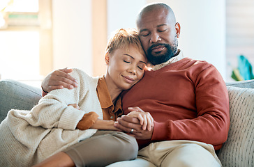 Image showing Love, relax and trust with a black couple on a sofa in the living room of their home together. Hug, marriage and romance with a mature man and woman bonding in the lounge of a house for calm peace
