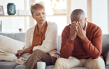 Image showing Divorce, stress and mature couple arguing on the sofa in the living room of their house. Frustrated, relationship problems and upset African man and woman speaking in the lounge of their home.