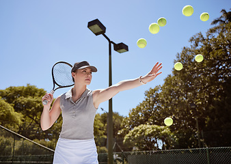 Image showing Tennis, tennis ball and woman serving for fitness training, cardio workout and sports exercise outdoors in summer. Focus, action and healthy athlete serves multiple balls on a tennis court in a game