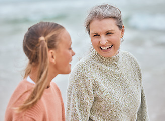 Image showing Family, children and beach with a senior woman and girl child bonding by the sea in nature. Kids, love and retirement with a grandmother and grandchild spending time together by the ocean outdoor