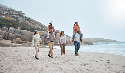 Image showing Family, walking and holding hands on beach holiday vacation. Happy grandparents, parents and children smile together for love trust bonding holiday or quality time adventure on sand ocean water