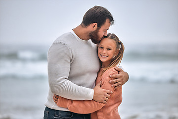 Image showing Family, beach and father kiss girl on vacation, holiday or trip outdoors. Love, care and affection hug of dad and kid bonding, having fun and enjoying quality time together on seashore or ocean coast