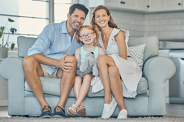 Image showing Happy, smile and portrait of a family on a sofa to relax and bond together in the living room of their home. Happiness, mother and father sitting with their girl child on couch in their modern house.