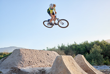 Image showing Nature, bike and cycling sports jump stunt on rocks ramp with fitness, training and exercise man. Athlete, bicycle and sport workout in Canada with mockup for professional athletic advertising.