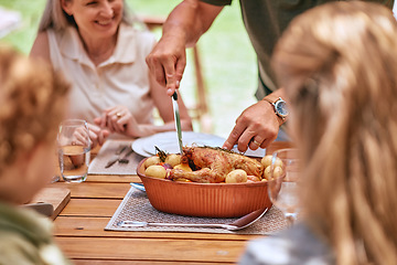 Image showing Turkey lunch, family and man cut food for celebration event, happy family reunion and enjoy quality time together on home patio. Love, happiness and group of people eating chicken meal at brunch