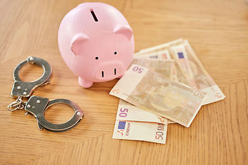 Image showing Piggy bank, money and handcuffs fraud crime for euro scam, corruption and criminal wealth exchange. Economy crisis, bankruptcy and illegal euros for taxes bribe or bank dollars payment offer.