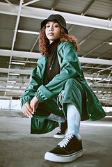 Image showing Fashion, beauty and black woman pose in parking lot with trendy, stylish and modern outfit. Portrait of girl with contemporary, edgy and urban style on floor of car park or garage in designer clothes