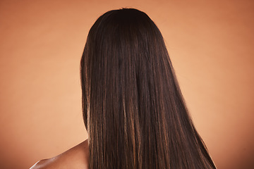 Image showing Woman, brown hair balayage and hair care, beauty salon shampoo and shine, smooth texture and extension wig, hair dye color or cosmetics on studio orange background. Back head of model long hair style