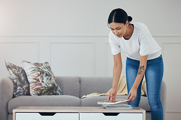 Image showing Cleaning, living room books and hygiene woman tidy apartment, home or desk table surface for domestic housework. Magazine, maid service and casual house cleaner working, housekeeping or doing chores