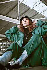 Image showing Fashion, green designer clothes and black woman relax on floor with gen z streetwear, hip hop style or rap aesthetic. Creative brand apparel, edgy outfit and luxury fashion model with cool attitude