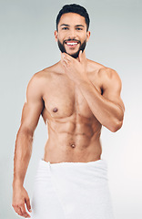 Image showing Skincare, beauty and portrait of man with towel in studio on white background. Wellness, body care and male model pose for for facial cleanse, skincare products and hygiene for washing and cleaning