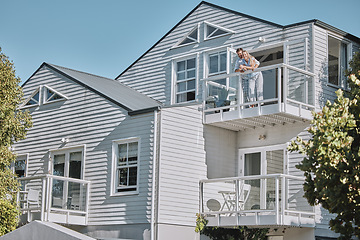 Image showing Real estate, house and couple relax on balcony of their dream home, happy, proud and laughing. Property, family and happy man, woman and homeowners enjoy conversation, joke and terrace view together