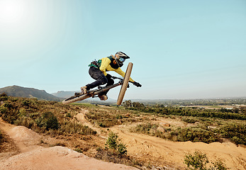 Image showing Mountain bike, man and air jump, action and bicycle cycling, challenge and adventure, freedom and dynamic performance on blue sky mockup. Biker, athlete and adrenaline, energy and extreme sports race