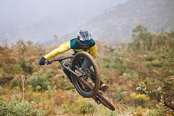 Image showing Mountain bike, man and air jump, action and bicycle stunt, challenge and adventure, freedom or dynamic risk in outdoor competition race. Biker athlete, sports adrenaline and energy for extreme sports