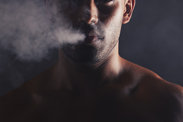 Image showing Smoke cloud, face and man in studio for addiction, smoker and bad habit on black studio background mockup. Tobacco, vape or marijuana with guy model pose with space for awareness, cancer and health