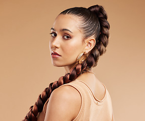 Image showing Beauty, fashion and makeup, woman with braid, serious face and luxury cosmetics and hair care. Health, wellness and skincare, portrait of cool beautiful girl from Mexico with long braided hairstyle.