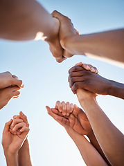 Image showing Low angle, group and holding hands in support, trust huddle and motivation for global success, volunteer community or diversity. People, friends or teamwork collaboration in circle for climate change