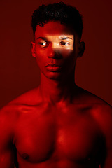 Image showing Neon red, dark light and black man with artistic lighting design, beauty and creative facial shadow. Luxury skincare glow, aesthetic creativity and health wellness model isolated on studio background