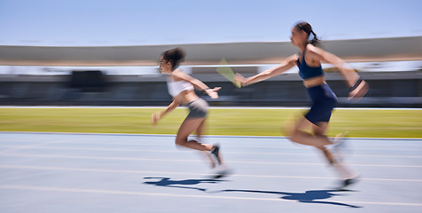 Image showing Relay race, running and sports women at a stadium for training, energy and workout. Sport, runner and baton pass on a running track by athletic team for fitness, marathon and speed performance