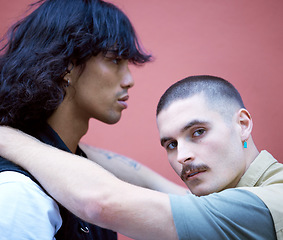 Image showing Love, freedom and lgbtq couple relax, embrace and bond against a wall in a city, proud and content together. Gay, men and portrait of diverse lovers embracing in a red background, attitude and cool