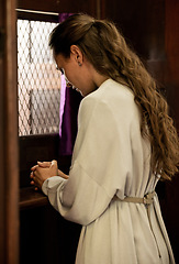 Image showing Christian woman, church and confessional, worship and prayer for forgiveness, mercy and peace to holy God, praying and faith. Spiritual person in booth, sorry about sin, secret and trust to priest