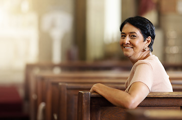 Image showing Senior woman, christian and happy in church, spiritual and religion after service, smile and lifestyle. Elderly female smile, portrait and empowerment while sitting in wood bench in catholic chapel