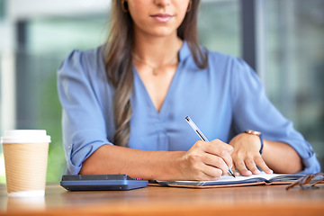 Image showing Business woman, accountant and notebook while writing notes and using calculation for budget, profit and bookkeeping while sitting at a desk. Hands of entrepreneur with planner for financial report