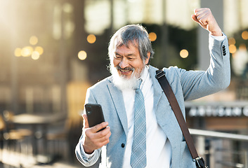 Image showing Happy businessman, winner or phone celebration for lottery, success corporate deal or financial company growth in city. Smile, fist pump or wow senior man winning online competition on smartphone app