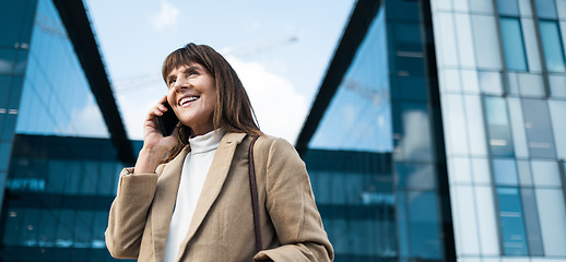 Image showing Business woman, phone call and smile for communication, networking and conversation with contact or investor outdoor by office buildings. Happy entrepreneur with smartphone with 5g network connection