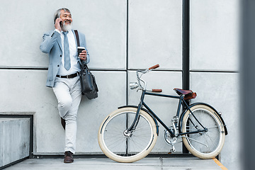 Image showing Bicycle, phone call and business man in city for communication, networking and carbon footprint travel marketing update with smile. Happy, healthy senior corporate manager coffee, bike and cellphone