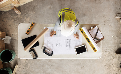 Image showing Engineering, building and aerial of construction worker with blueprint, tools and digital tablet on desk. Architect check engineering design, floorplan and drawing at workstation in construction site