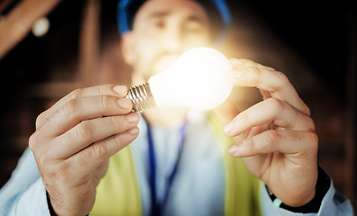 Image showing Idea, light and man engineer holding a lightbulb for vision, innovation and construction. Contractor, construction worker and designer lights for a maintenance project with an architect and bulb