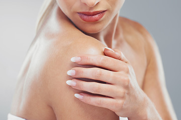 Image showing Beauty, body and zoom of a woman hand for self care and skincare on a grey studio background. Cosmetic, bodycare and skin care of a female arm or shoulder for health or wellness on a backdrop