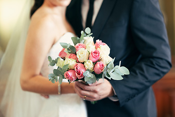 Image showing Flower bouquet, wedding celebration and couple together for commitment, love and marriage of bride and groom. Flowers in hands of young man and woman at union event with trust, support and care