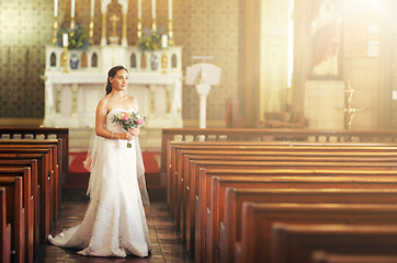 Image showing Wedding, bride and church with a woman holding flower bouquet while thinking about marriage, future and dream before walking down the aisle. Model in a white wedding dress for commitment and ceremony