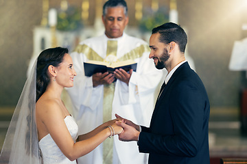Image showing Couple getting married, wedding vows and love commitment at the alter of church during marriage ceremony. Happy bride, groom and Christian priest performing rites, religious and spiritual connection