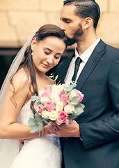 Image showing Love, happy and flowers with couple on wedding for affection, kiss and embrace after marriage ceremony. Relationship, lifestyle and hug with man and woman with bouquet for romance, event or reception