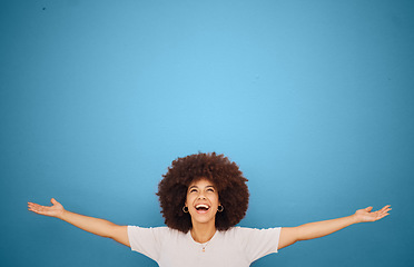 Image showing Winner, mockup and excitement with a black woman in celebration in studio on a blue background for marketing or advertising. Motivation, space and product placement with a female cheering in victory