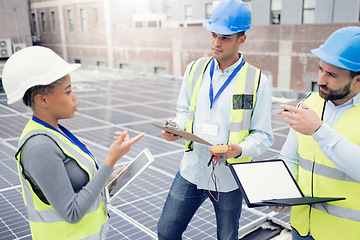 Image showing Tablet, solar energy and teamwork with an engineer, designer and technician meeting on a roof in the city for renewable energy. Engineering, solar panel and energy with a man and woman group at work