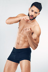 Image showing Body, muscle and boxing with a man athlete in studio on a gray background for sports or fitness. Healthy, muscular and training with a macho male boxer inside for exercise or a bodybuilding workout