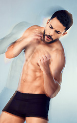 Image showing Body, strong and boxing with a man muscular model in studio on a gray background for health or fitness. Sports, muscle and training with a male athlete or boxer punching during an exercise workout