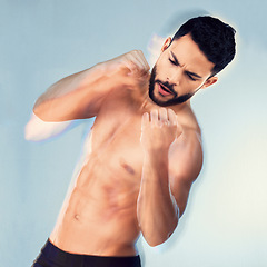 Image showing Fitness, studio and man shadow boxing for exercise, wellness or strength on a blue background. Sports, health and boxer or male fitness model from India practicing punch during workout or training.