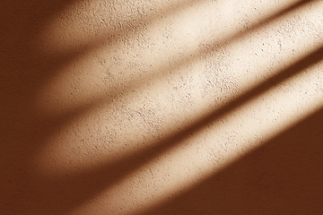 Image showing Orange concrete facade with sunlight shadow background. Indoor s