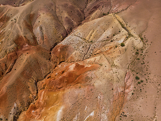 Image showing Aerial shot of the textured yellow nad red mountains resembling the surface of Mars