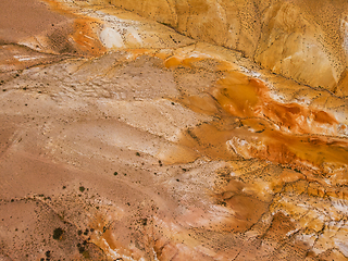 Image showing Aerial shot of the textured yellow nad red mountains resembling the surface of Mars