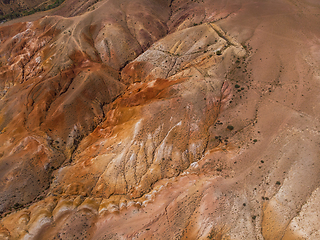 Image showing Aerial shot of the textured yellow nad red mountains resembling the surface of Mars