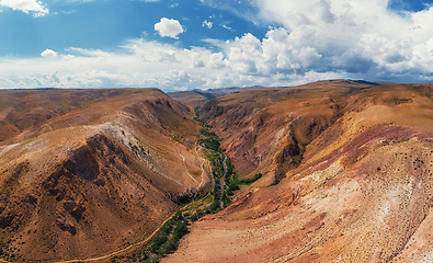 Image showing Aerial shot of the textured yellow nad red mountains resembling the surface of Mars